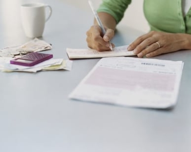 woman filling out divorce paperwork